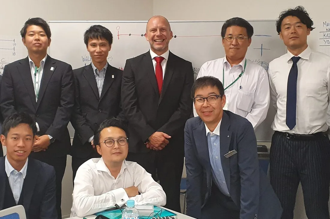 Jason with a client leadership team in a training room in Japan